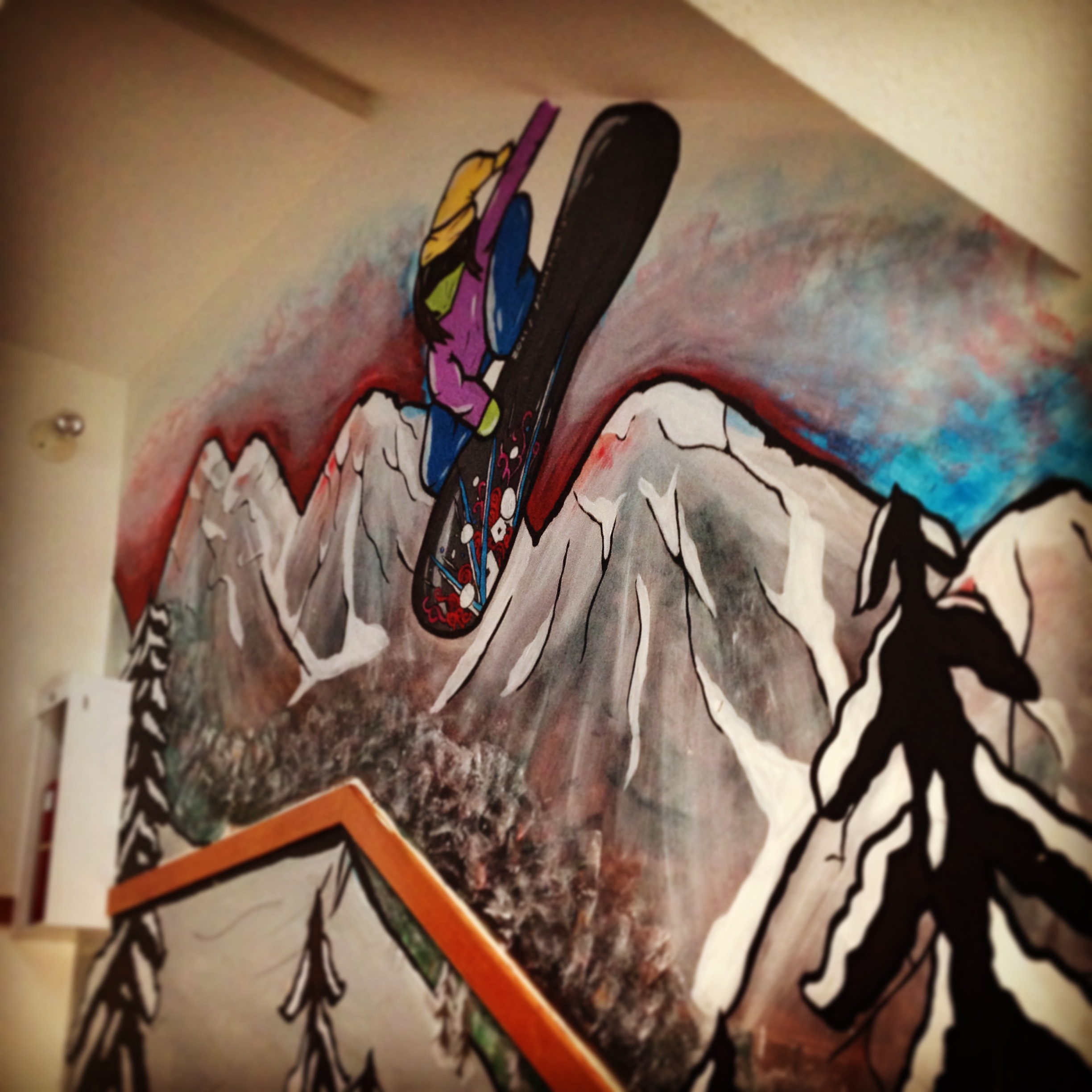 Snowboarding art coats the walls at Samesun Hostel in Banff, AB
